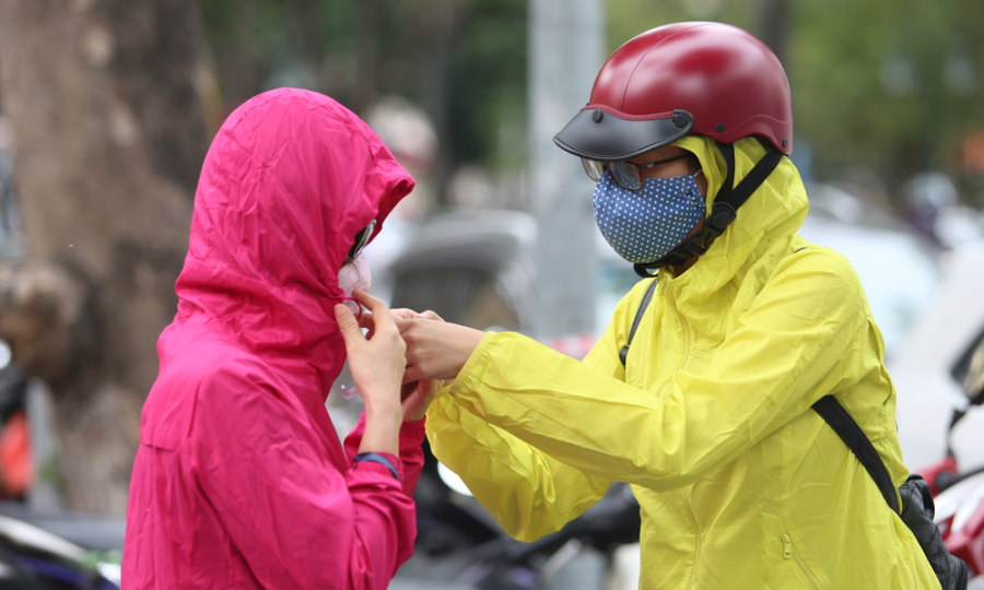 Chàng trai nhanh nhạy khi trời mưa biết tìm áo mưa để dùng